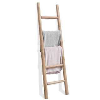 A light wooden blanket ladder with two towels hanging on it