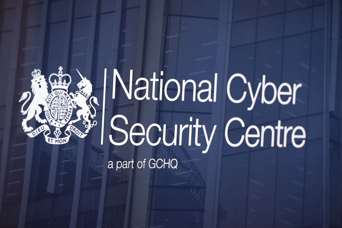 Top 12 most-exploited security vulnerabilities: NCSC logo superimposed with a translucent background in front of an office building