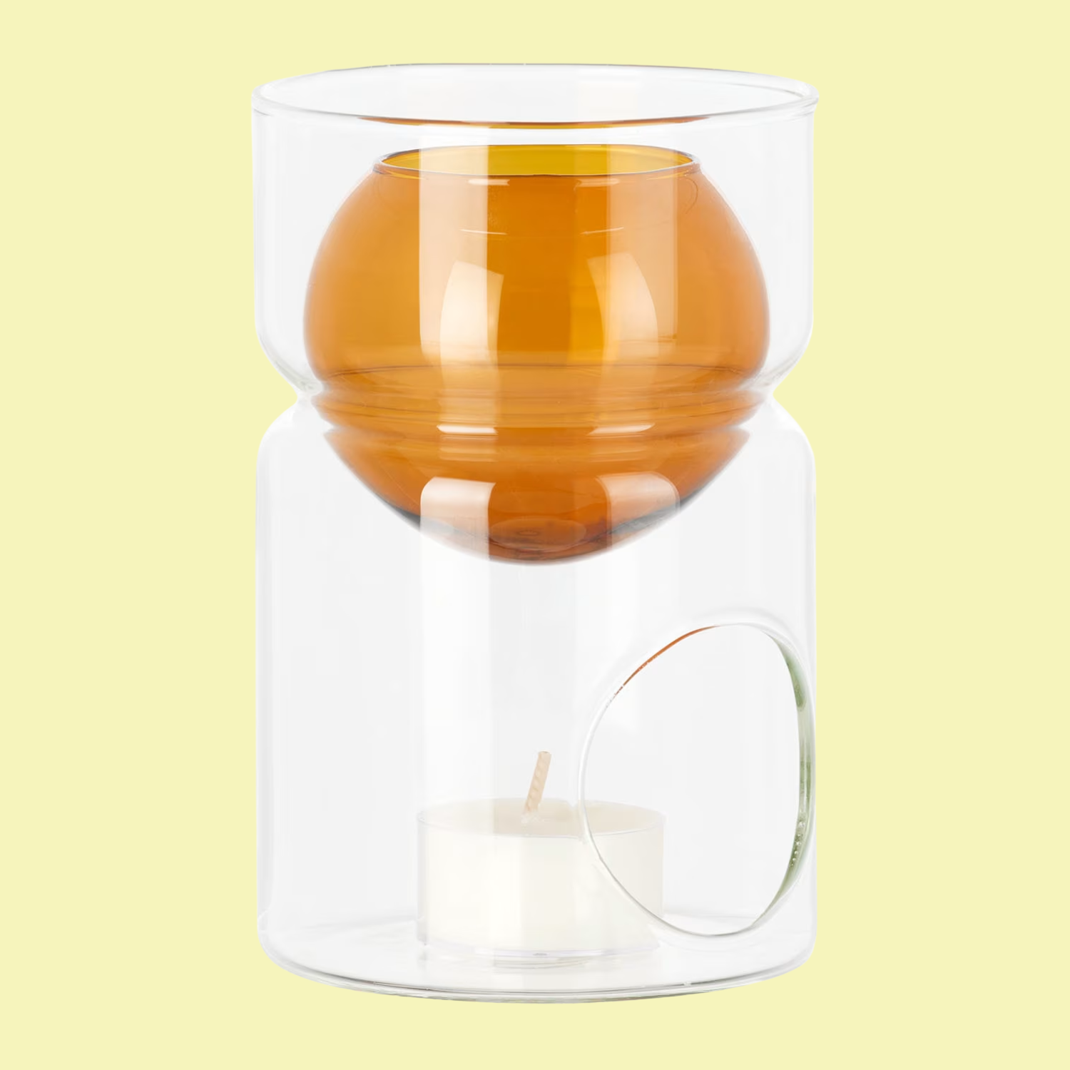A clear and amber glass essential oil burner with a telight