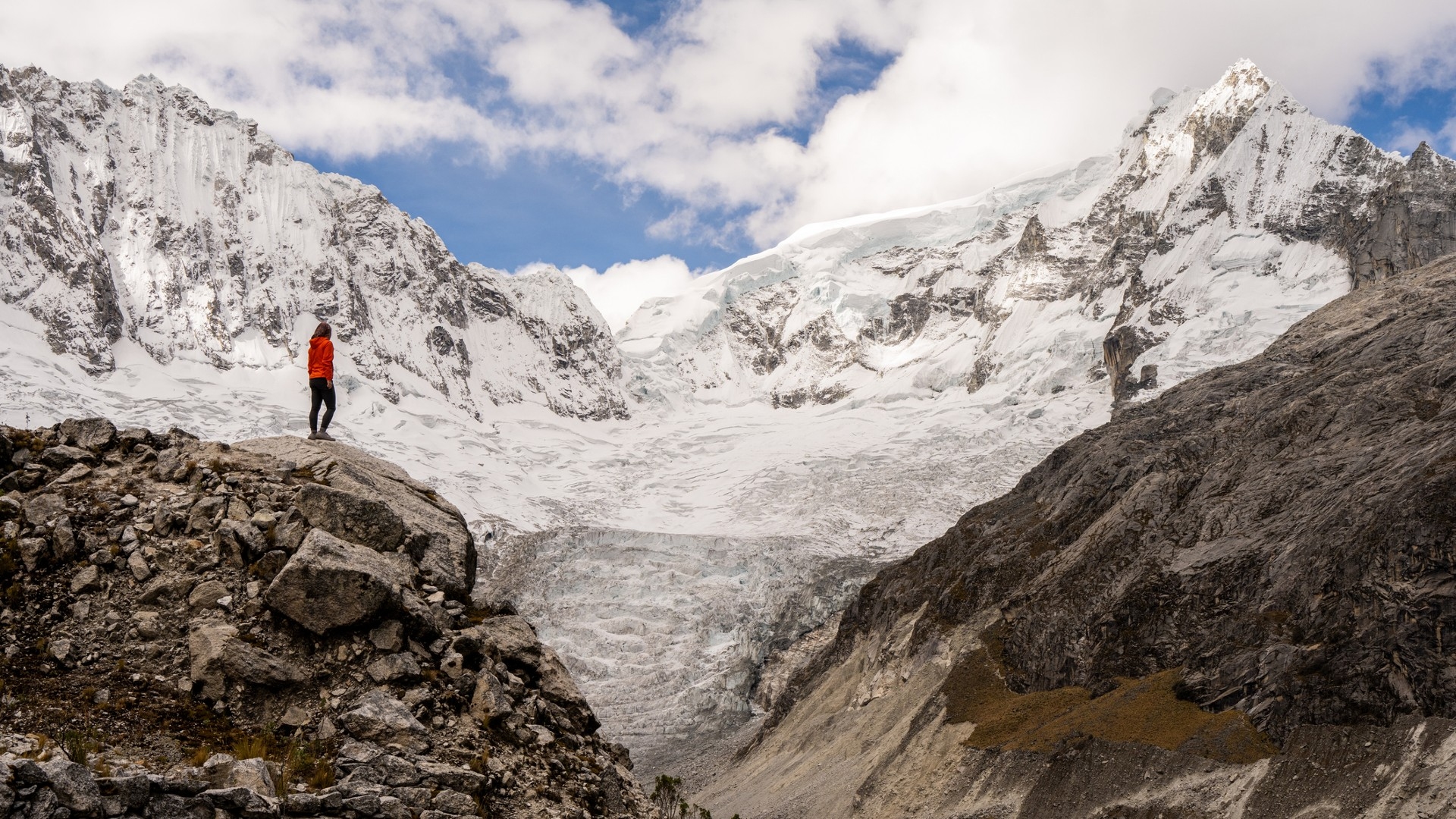 Woman looking to the peak of the Ranrapalca Glacier (6162 m) in Ancash Andes, Peru.