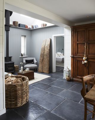 Open plan living room with a dark grey tumbled flagstone floor