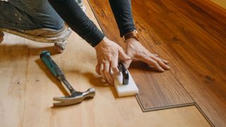Person laying laminate flooring