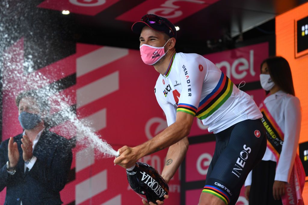 PALERMO ITALY OCTOBER 03 Podium Filippo Ganna of Italy and Team INEOS Grenadiers World Champion Jersey Celebration Champagne Mask Covid safety measures during the 103rd Giro dItalia 2020 Stage 1 a 151km Individual Time Trial stage from Monreale to Palermo ITT girodiitalia Giro on October 03 2020 in Palermo Italy Photo by Tim de WaeleGetty Images