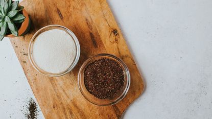 Spices in glass bowls on a wooden chopping board