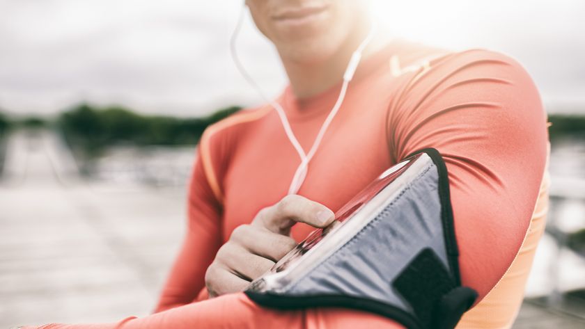 A woman looking at a running app on her smartphone