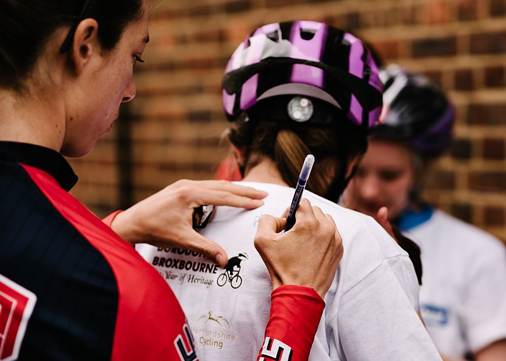 Heather Fischer singing autographs at the start