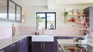 purple kitchen with hexagonal pink wall tiles and white worktops