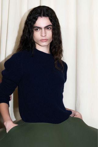 A model backstage at JW Anderson SS25 wearing boyish brows, a key Spring/Summer 2025 Fashion Month beauty look