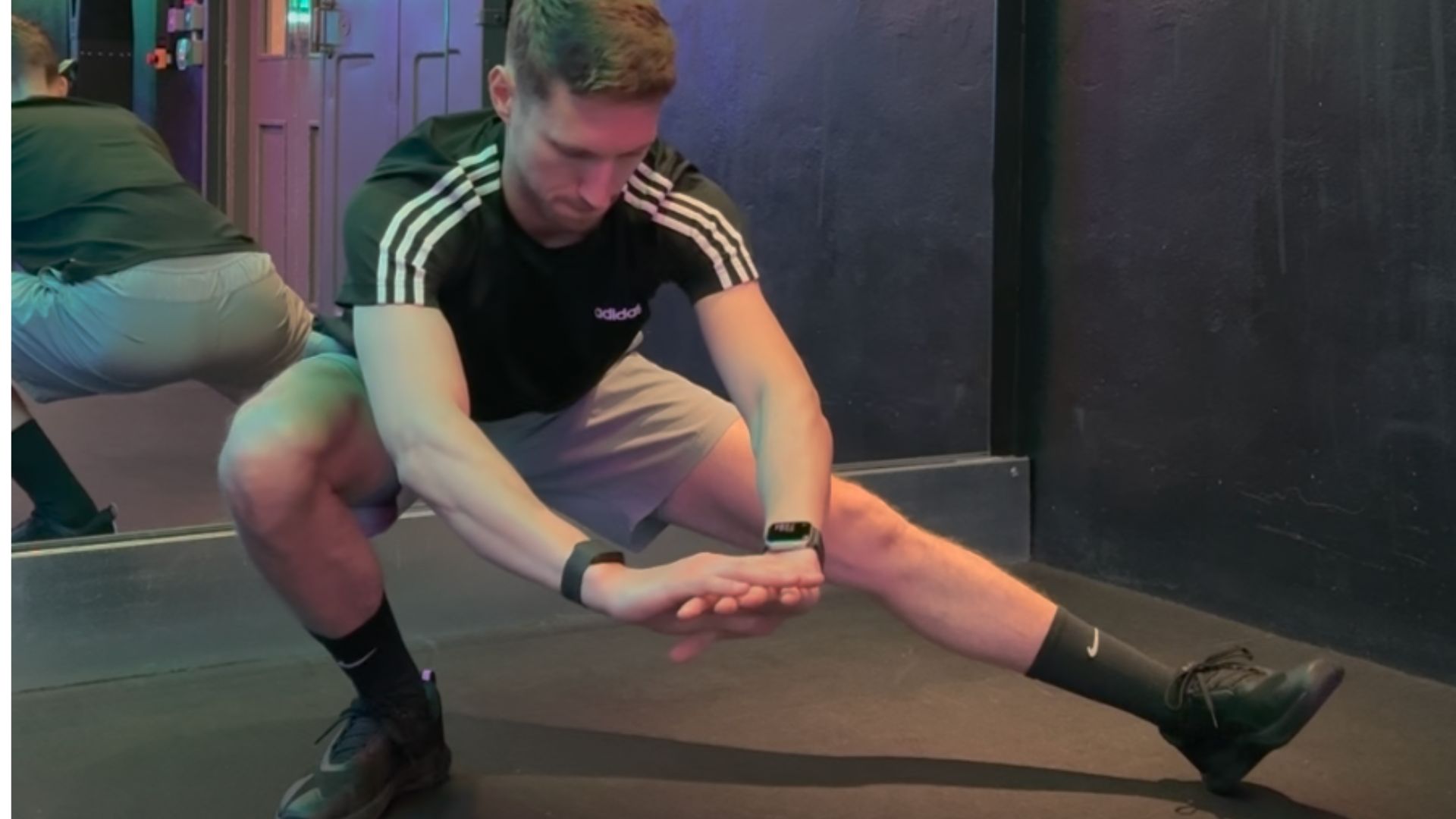 man in cossack squat