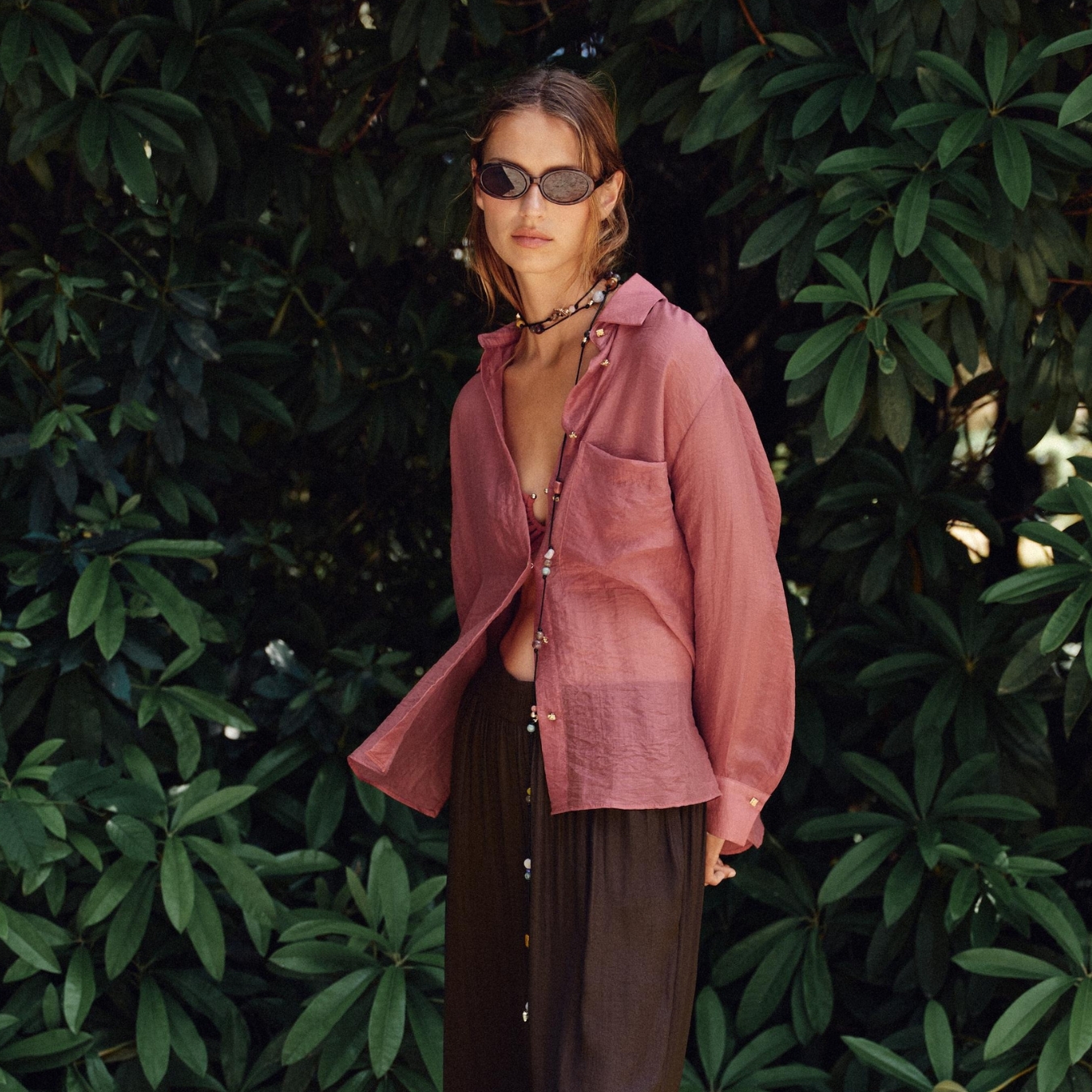 Model wearing a pink Zara shirt outfit. 