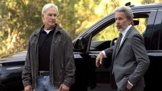 Mark Harmon and Gary Cole standing next to black SUV in NCIS