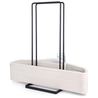 A black stacking hanger organizer with a stack of beige hangers 