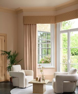 plaster pink light and airy living room with large windows