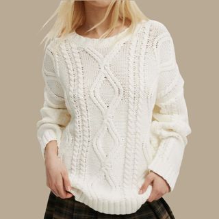 flat lay image of a woman wearing white jumper