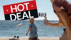 Family taking video with DJI OM 5 on a beach, with deal badge in background