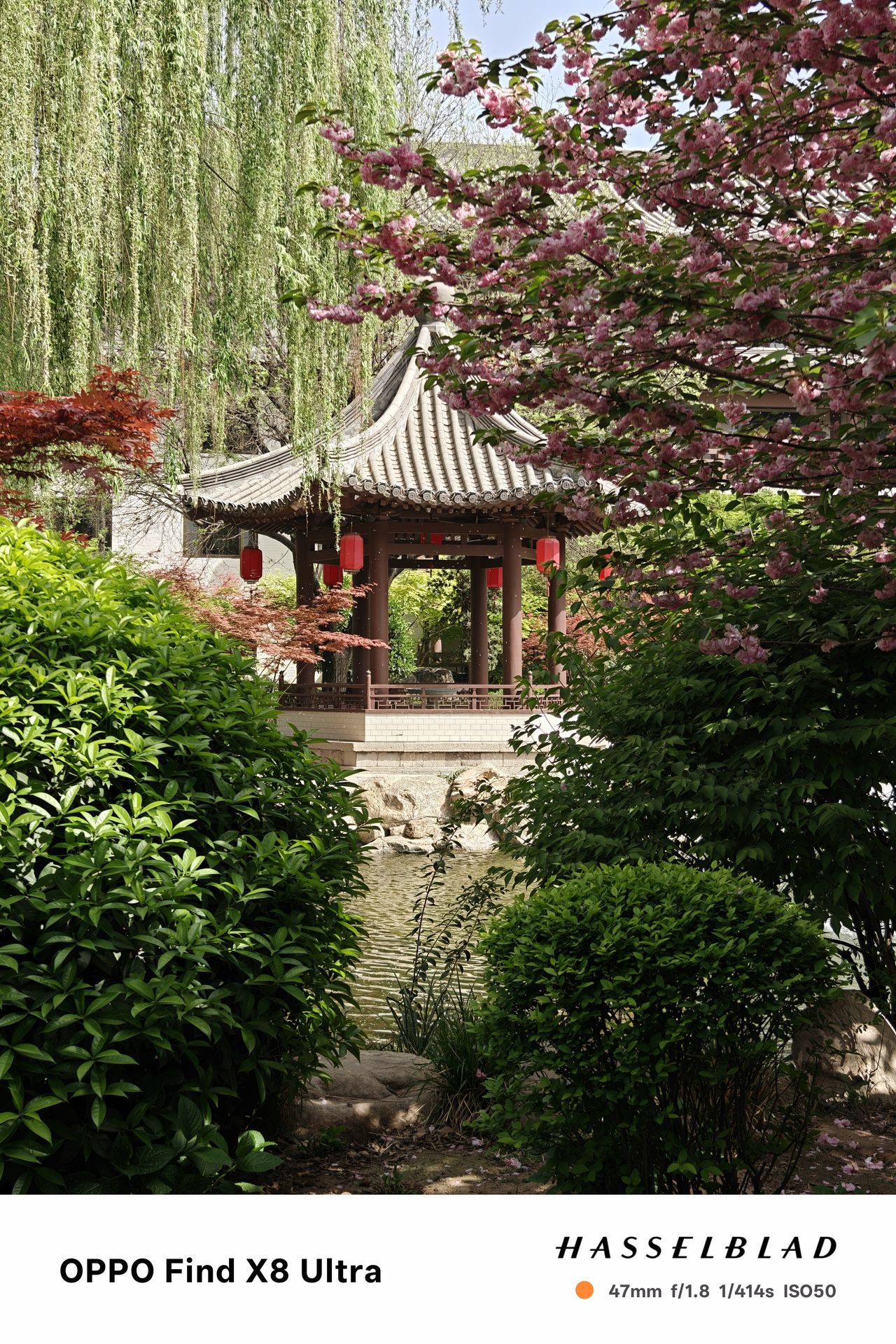 A pagoda in front of a lake surrounded by trees