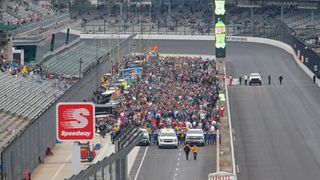 The crowd gathers on the starting grid prior to the start of the IndyCar Grand Prix on May 11, 2019, at the Indianapolis Motor Speedway Road Course in Indianapolis, Indiana