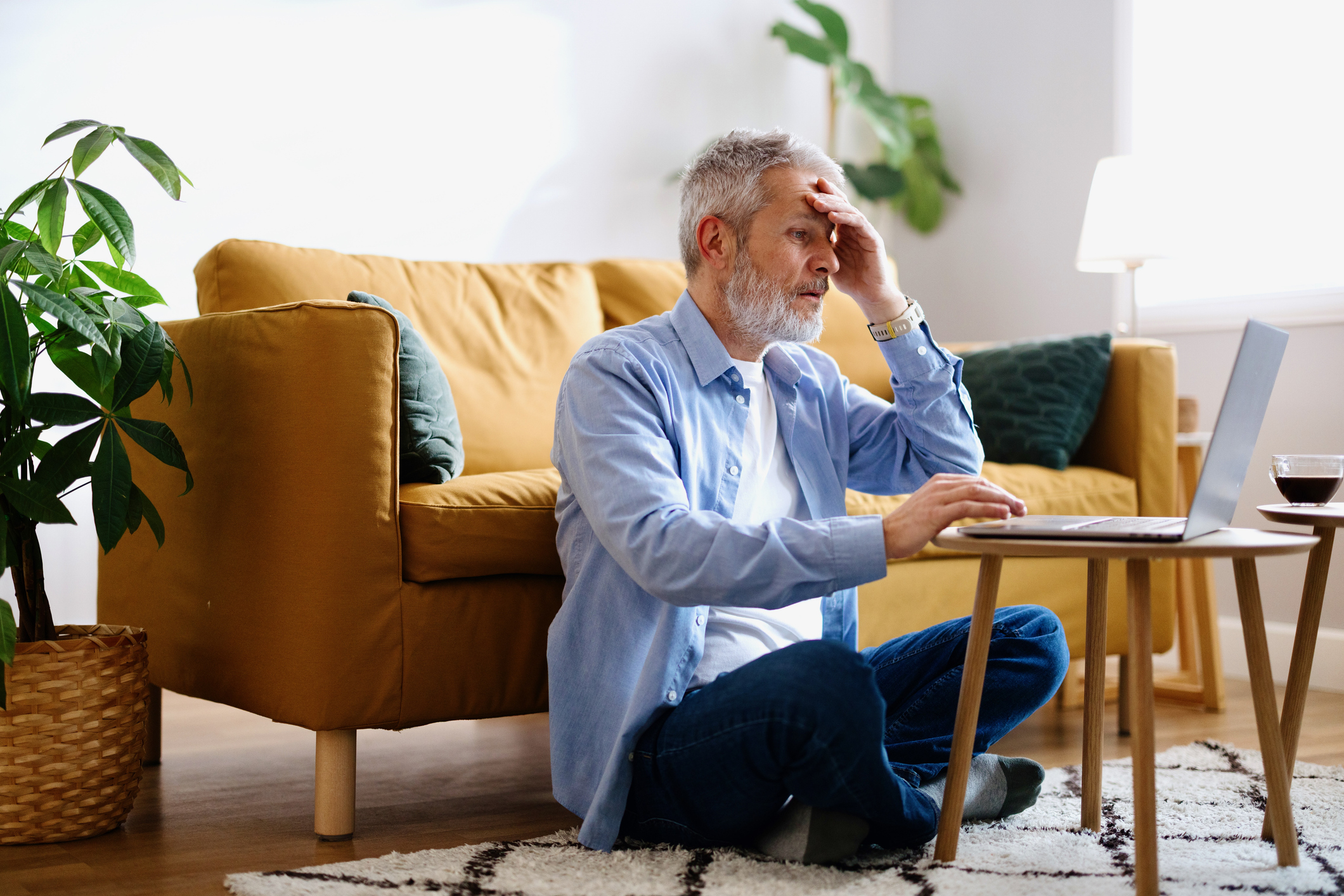 Stressed man working on a laptop from home