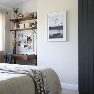 Bedroom with desk in corner and open shelving