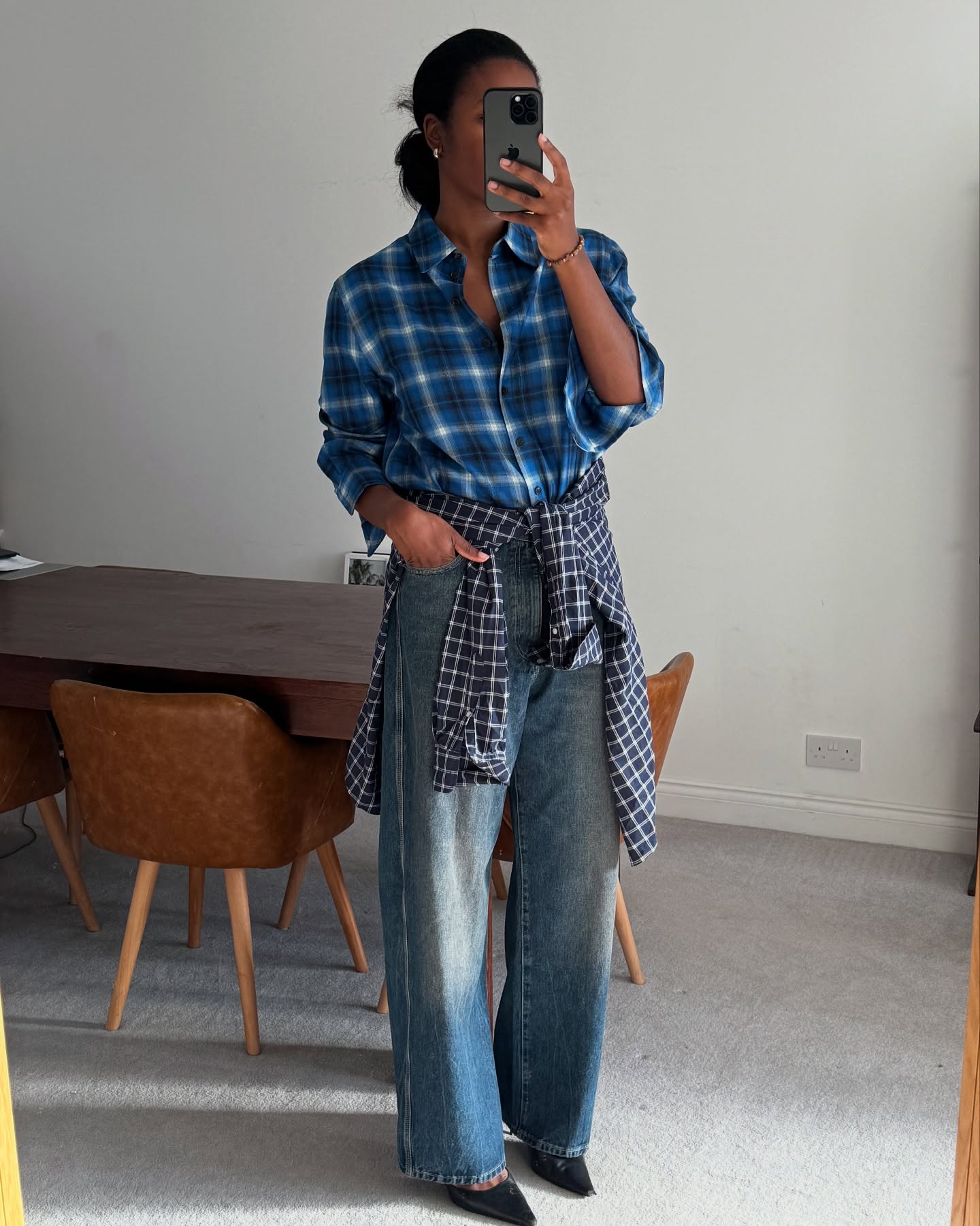 An image of @nlmarilyn wearing the flannel top trend with straight leg jeans.