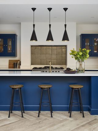 Modern shaker kitchen with blue island and trio of lights