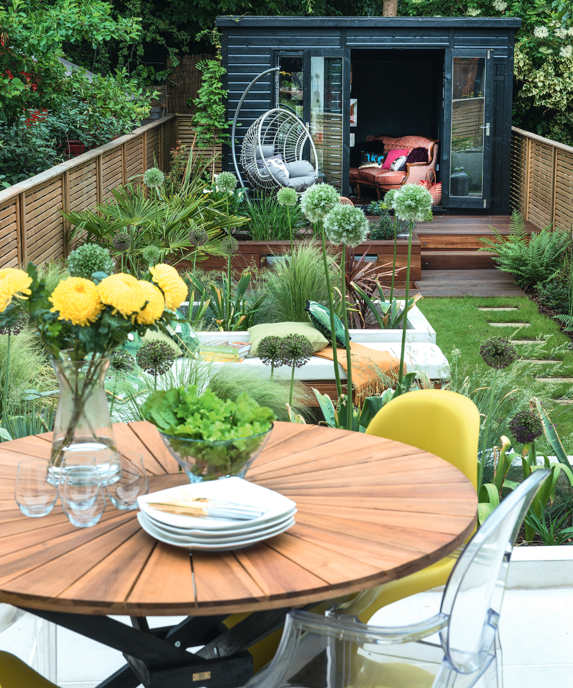 Small urban garden designed to maximise space with the addition of spheres