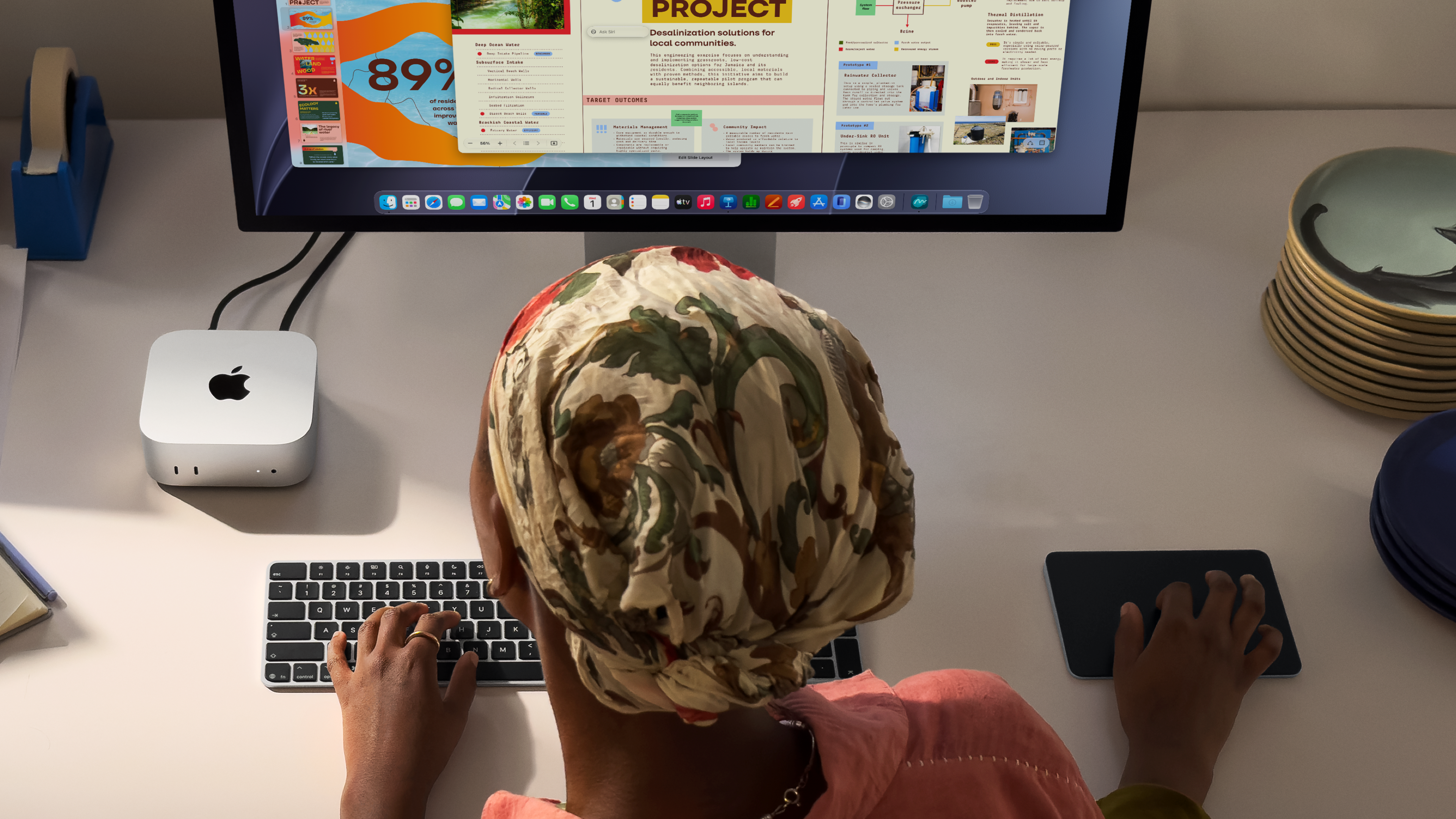 A woman working on the Mac mini with M6 connected to a Studio Display