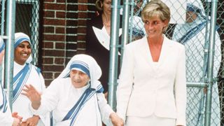 NEW YORK, NEW YORK - JUNE 18: Diana, Princess of Wales, wearing a cream suit, holds hands with Mother Teresa following a meeting in the Bronx on June 18, 1997 in New York, NYC.