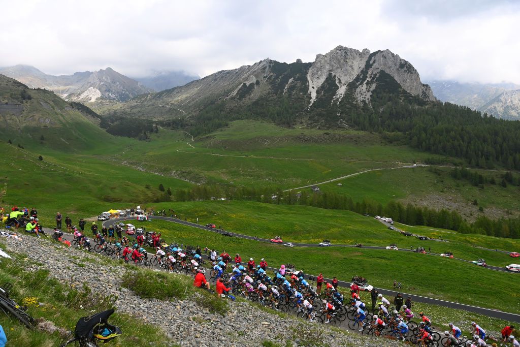 APRICA ITALY MAY 24 Ben Tulett of United Kingdom Jhonnatan Narvaez Prado of Ecuador Nicolas Jonathan Castroviejo of Spain and Team INEOS Grenadiers and Richard Carapaz of Ecuador and Team INEOS Grenadiers Pink Leader Jersey lead the peloton passing through a mountainous landscape at the Passo Crocedomini 1938m while fans cheer during the 105th Giro dItalia 2022 Stage 16 a 202km stage from Sal to Aprica 1173m Giro WorldTour on May 24 2022 in Aprica Italy Photo by Tim de WaeleGetty Images