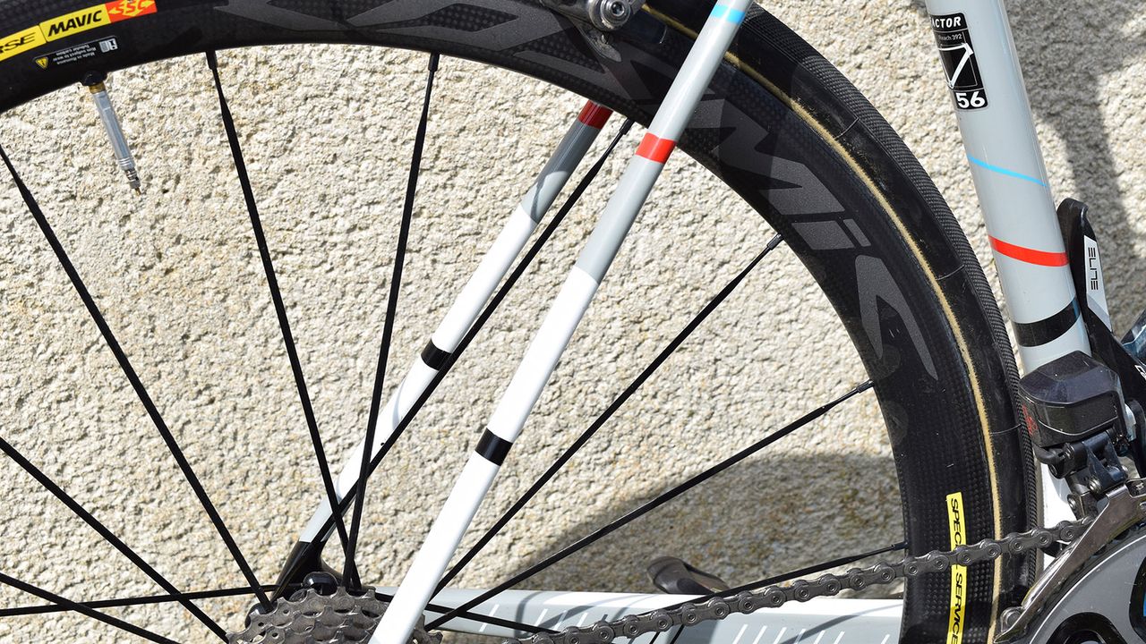 Flashes of red, white, black and blue feature on the frameset to represent the marking lines on the Roubaix velodrome