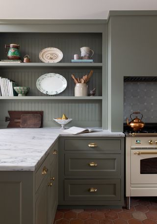 A kitchen with a darker green