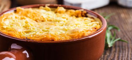 Shepherd's pie, traditional British dish with minced meat and mashed potato on rustic wooden table