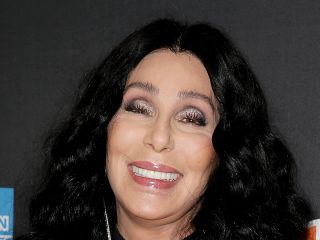 Cher smiles for the camera on the red carpet