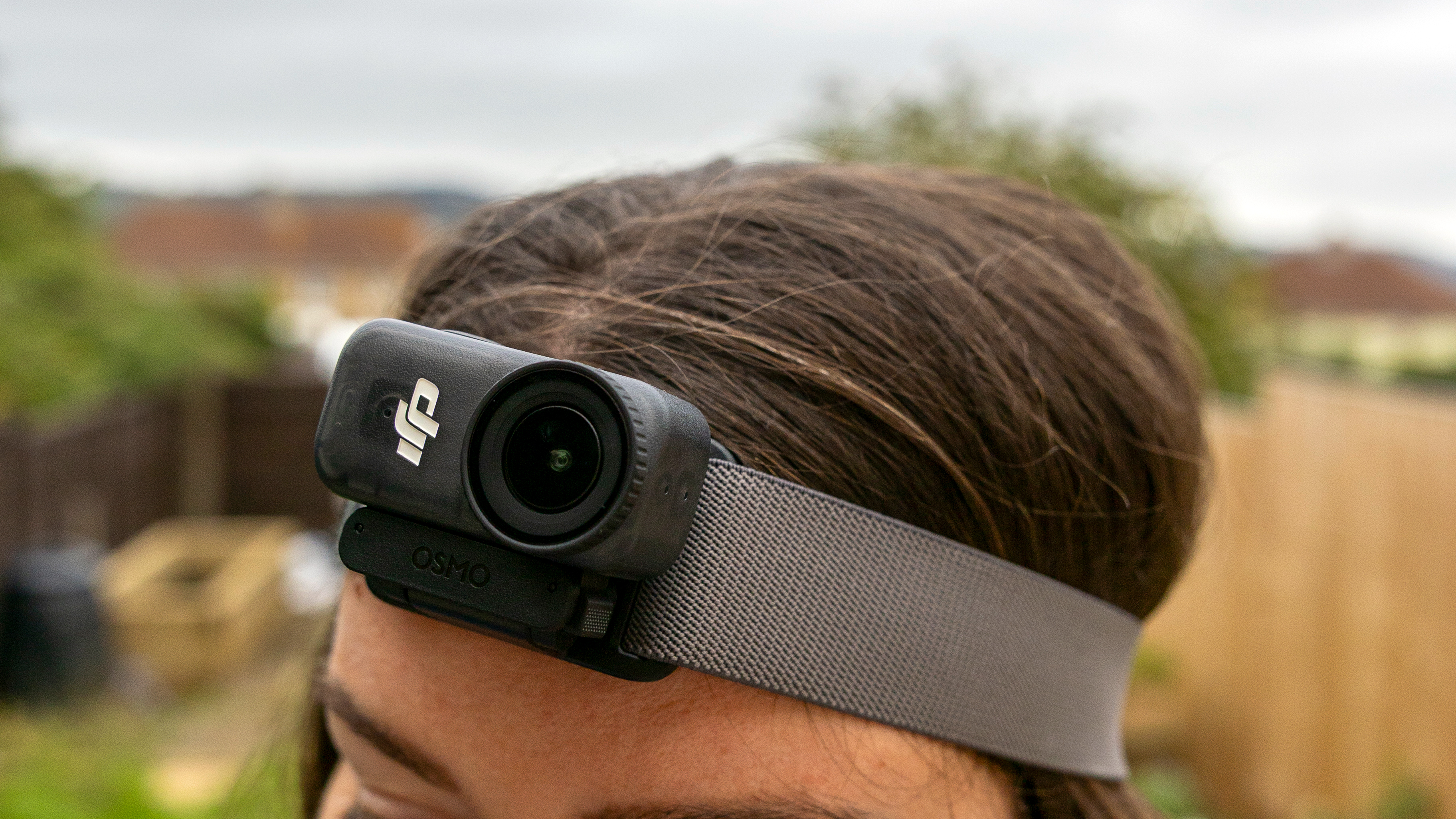 A female photographer wearing the DJI Osmo Nano on a headband