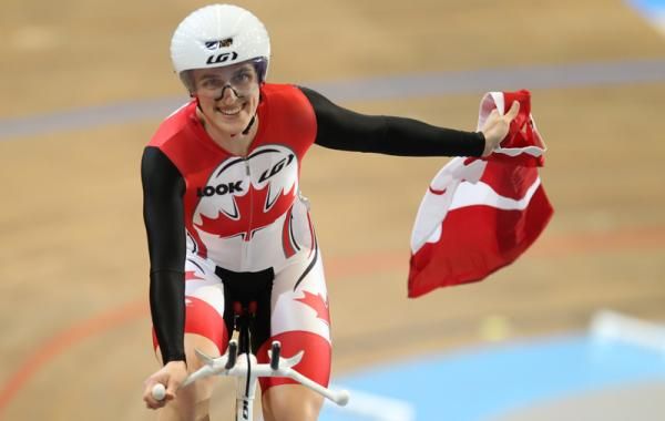 Tara Whitten flies the Canadian flag after victory in the Omnium.