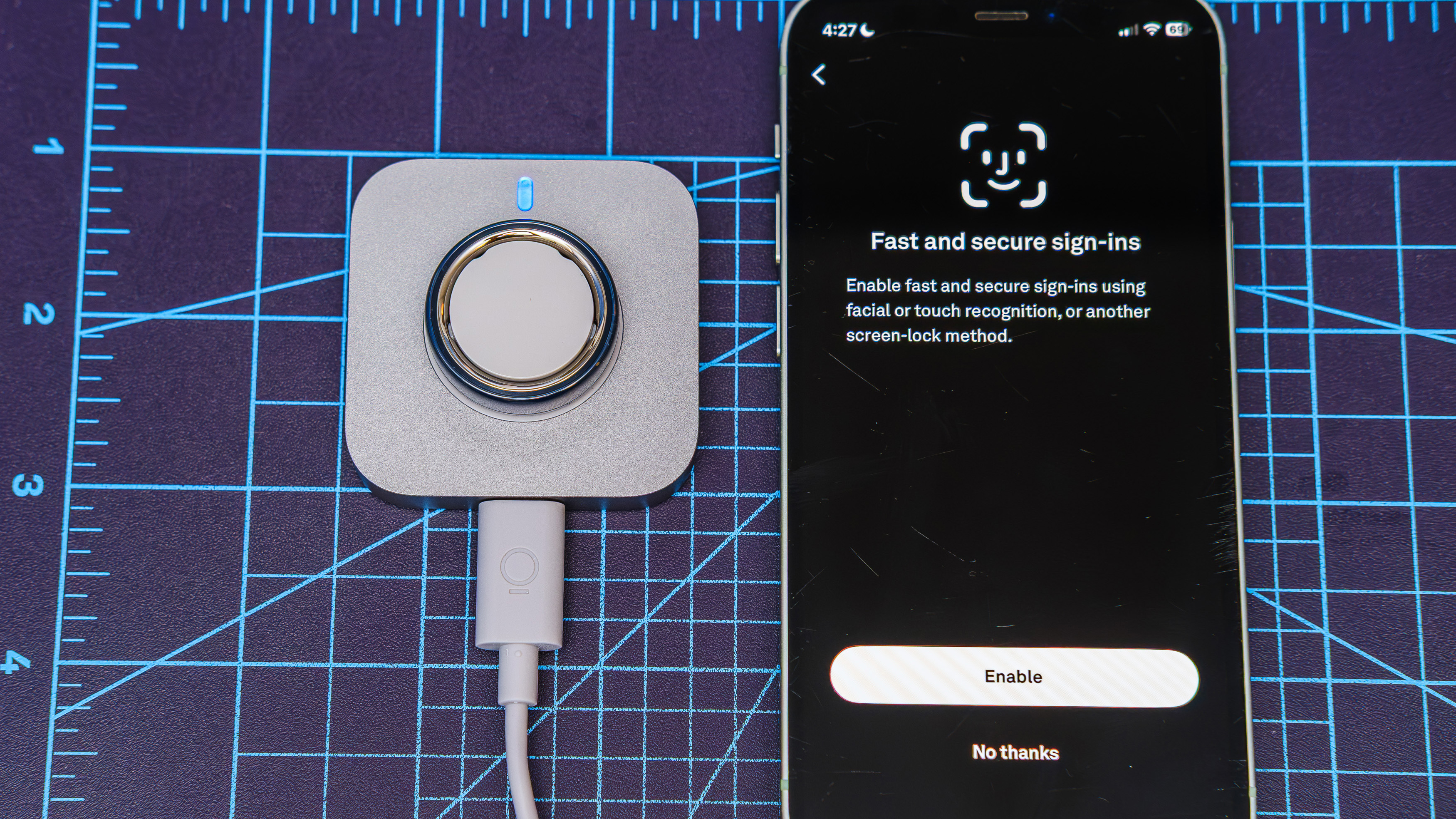 Oura Ring 4 Ceramic close-up showing the setup and pairing process using an iPhone