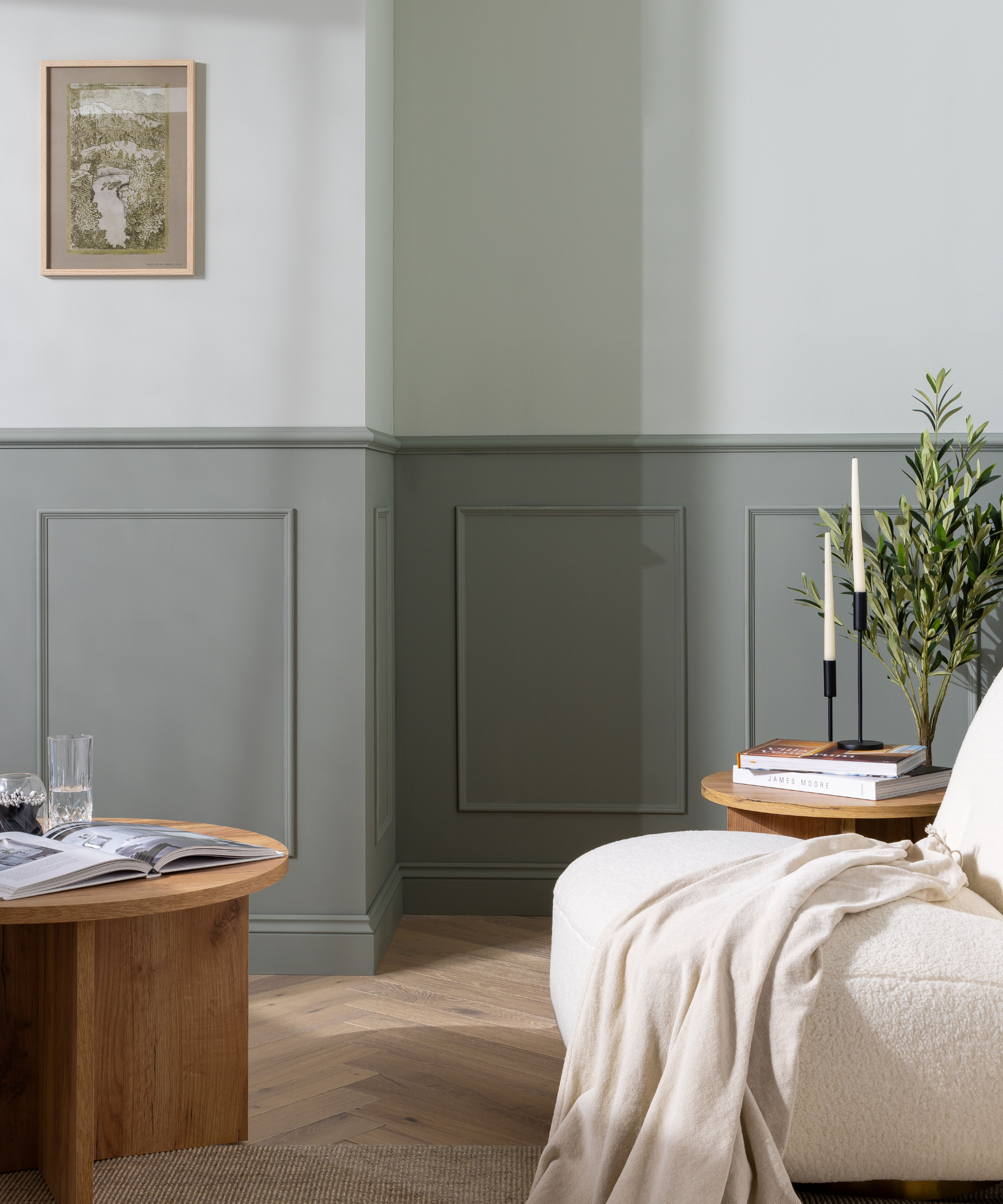 Living room with grey wainscotting paneling and a lighter gray wall above it