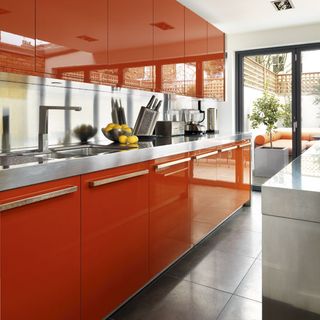 kitchen area with orange wall units