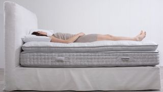 woman lying on a Button & Sprung mattress topper on a bed