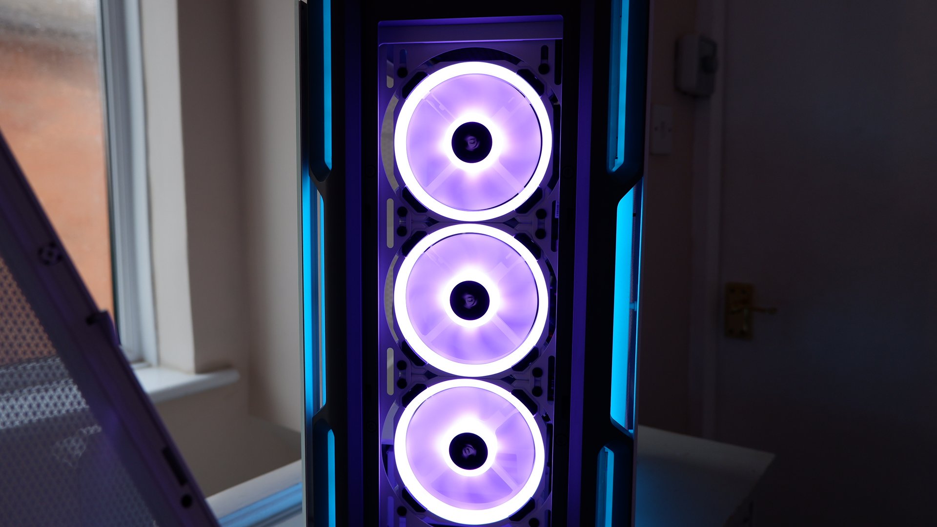 Corsair iCUE 5000T RGB mid-tower PC case with RGB lighting enabled in blue and pink