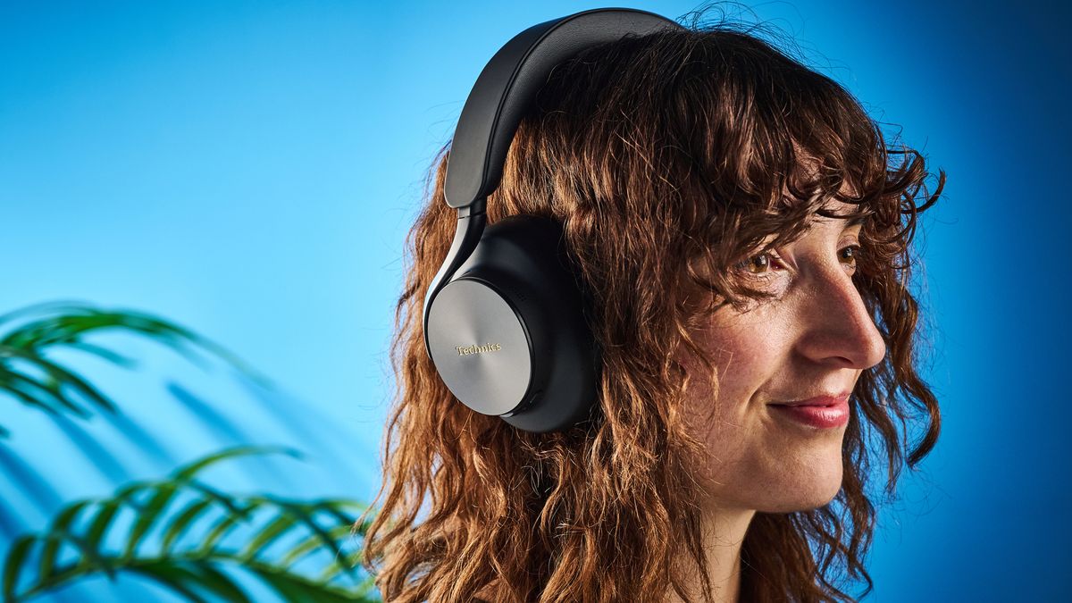 the technics eah-a1000 headphones with a gold technics logo photographed against a blue background