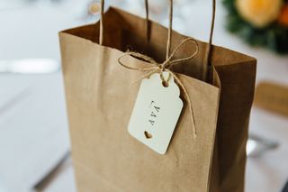 a close up of a brown paper gift bag with a gift tag saying 'Ava'