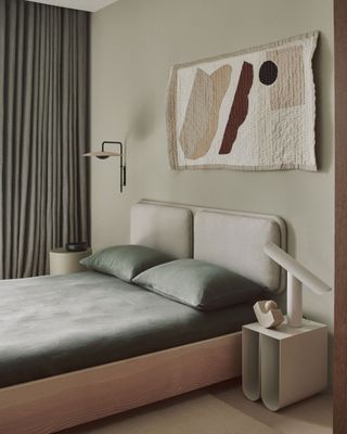 a neutral bedroom with wall art