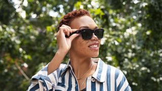model wearing facebook Ray-Ban Stories smart glasses outdoors