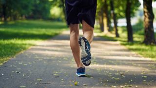 Do running shoes make you faster? Image shows person running in park
