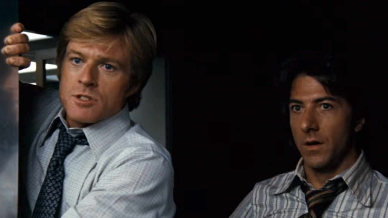 Robert Redford on the left, holding an elevator door open with Dustin Hoffman on the right in All the President's Men