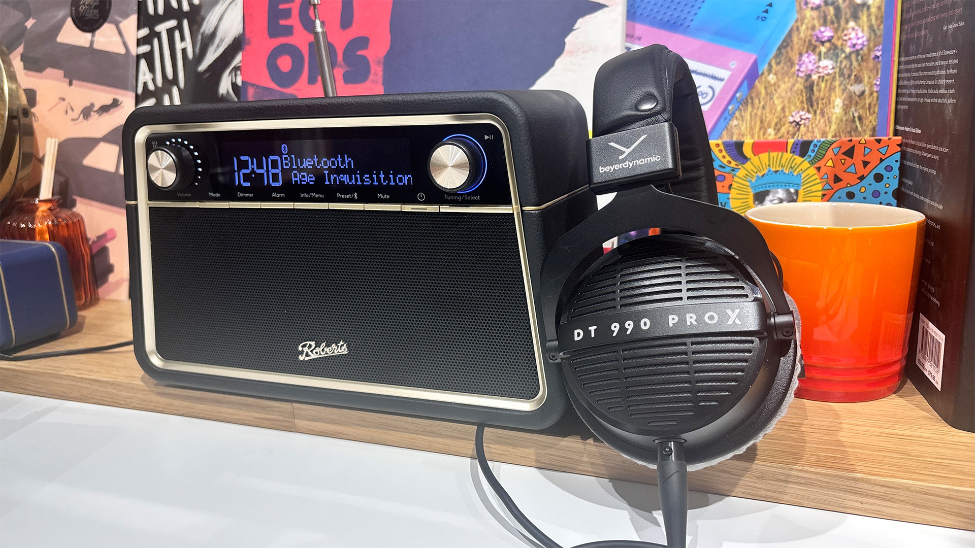 Roberts Reva radio on busy shelf with Beyerdynamic DT 990 Pro X headphones placed next to it