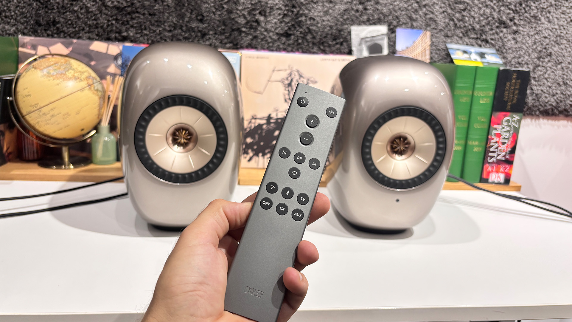 KEF LS Luxe active speakers with remote in hand