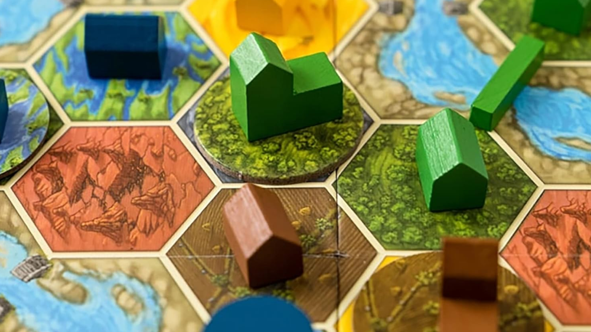 Wooden buildings on colorful land tiles from Terra Mystica