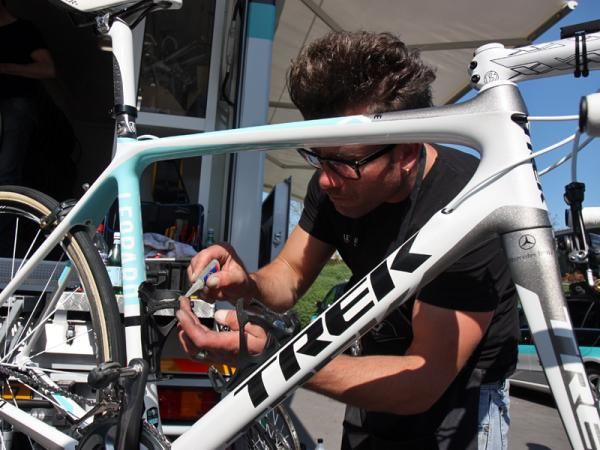 Leopard Trek mechanic Roger Theel applies a dab of cyanoacrylate glue to keep the edges of the friction tape from peeling off.